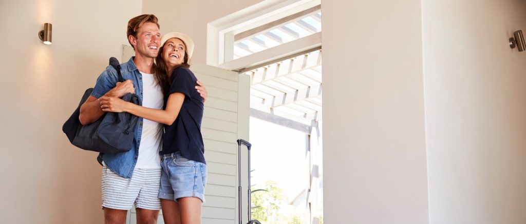 An upbeat couple discussing Airbnb Tax in their property.