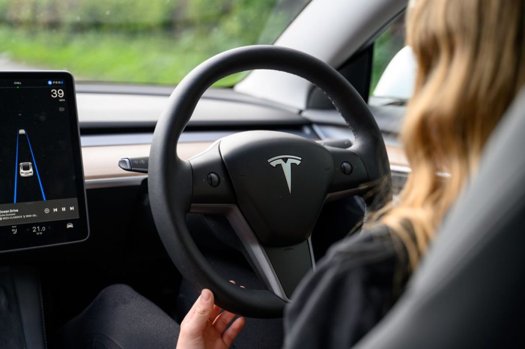 happy woman who has saved money on her next car with novated leasing and fbt exceptions on electric vehicles in australia