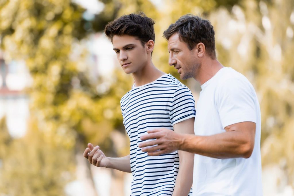 Teenager learning about money from parent