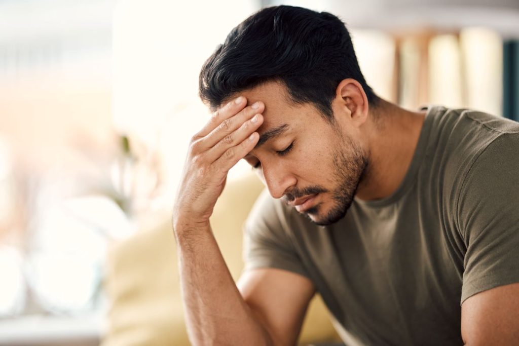 Man reflecting on financial mistakes and realising he low financial awareness